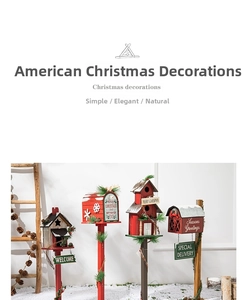 Detail of wooden American style Christmas birdhouse mailboxes with snow and pine needles