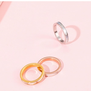 Three minimalist 3mm shell inlay rings in gold, rose gold and silver on pink background