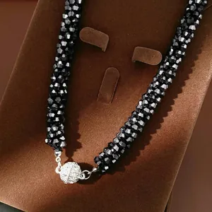 Elegant beaded necklace with black multifaceted crystals and crystal-set magnetic ball clasp