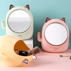 Detail of LED cat-ear makeup mirrors in pastel pink and green with matching organizer box