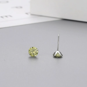 Detail of S925 sterling silver stamp on four-prong studs with green zircon stone