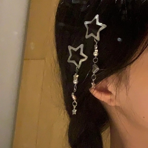 Silver star tassel hair clip with heart charms shown on model in a sweet cool style