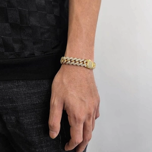 Close-up of gold plated Cuban link bracelet with pavé cubic zirconia on a wrist