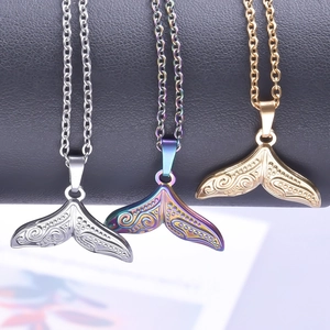 Engraved whale tail necklaces in silver, gold, and rainbow finishes on display