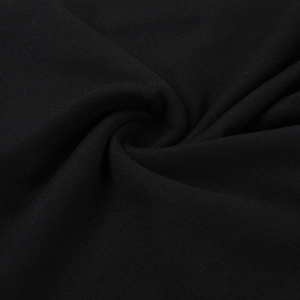 Detailed close-up showing the soft black fabric texture and fine knit weave of the dress