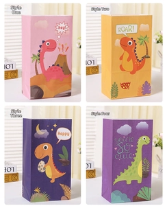 Close-up of four colorful dinosaur paper gift bags with cute cartoon patterns and handles
