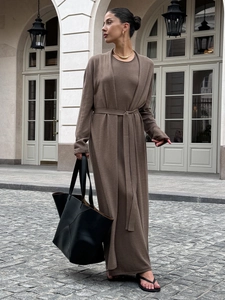 Detail of brown knit maxi dress and long cardigan set featuring fine textured fabric