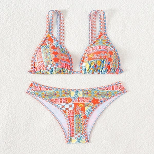 Detailed flat lay of vibrant floral bikini featuring ruffled trim and sleek double straps