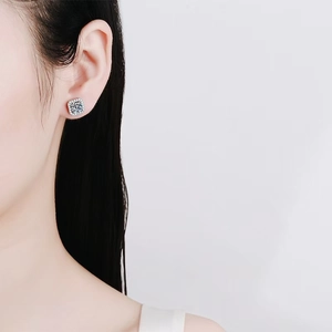 Luxurious square halo stud earrings with sparkling moissanite stones on female model