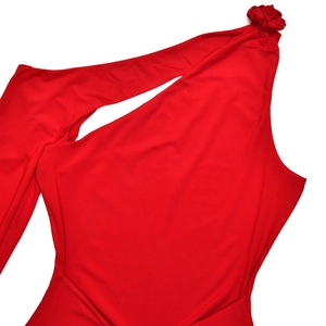 Detail of red one-shoulder dress showing elegant pleated flower decoration on shoulder