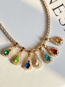 Detail of 18k gold plated tennis necklace with colorful pear-cut teardrop pendants