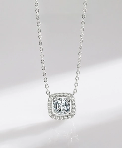 Macro shot of S925 sterling silver necklace with cushion-cut halo zircon pendant