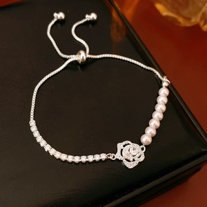 Detailed macro view of zircon flower pearl bracelet with an adjustable sliding clasp