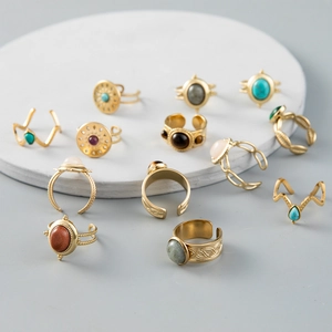 Detail of vintage bohemian gold rings with turquoise and gemstones on display stand