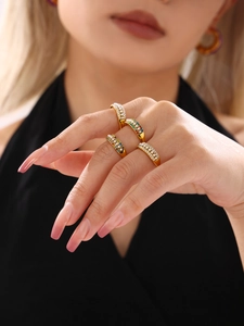 Macro detail of adjustable gold-plated rings with colorful cubic zirconia and small pearls