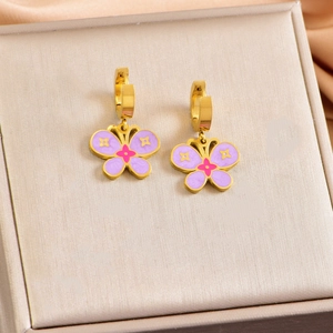 Detail of gold butterfly hoop earrings with purple and pink drip oil floral patterns