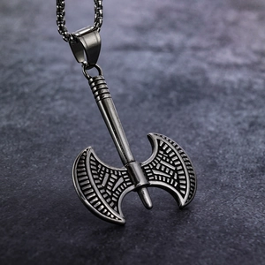 Close-up of vintage stainless steel double-headed Viking axe pendant with textured details