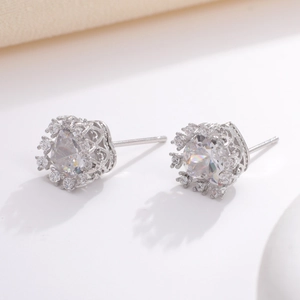 Close-up of geometric round zircon earrings with intricate hollow side patterns