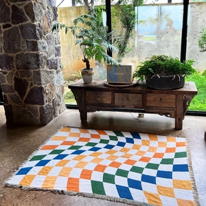 Detail of bohemian geometric checkered throw blanket with colorful fringe edges