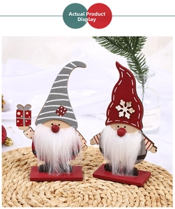 Close-up of wooden Christmas gnomes with long white fur beards and festive striped hats