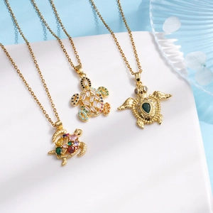 Three gold-plated sea turtle necklaces with colorful zircon stones and drop-shaped emeralds