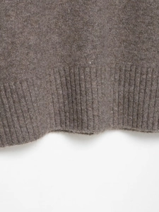Close-up of the ribbed hem on a soft V-neck knit sweater in coffee brown tone