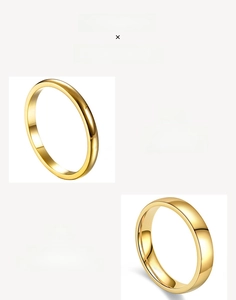 Detailed close-up of two minimalist 18K gold-plated polished stainless steel band rings