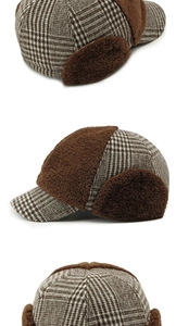 Close-up of brown plaid aviator hat showing earflap details and plush wool texture