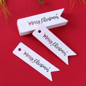 White pennant-shaped Christmas gift tags with Merry Christmas gold foil on red background