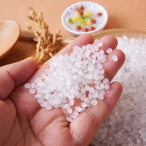 Handful of translucent white simulated rice beads for DIY slime and craft food decoration