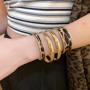 Four-piece stackable leopard print leather and gold bangle set for women
