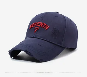 Detail of red SEVENTH 7 3D embroidery on distressed navy blue cotton baseball cap