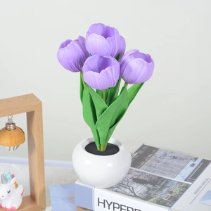 Detailed view of purple LED tulip lamp in white ceramic pot for bedroom ambiance lighting