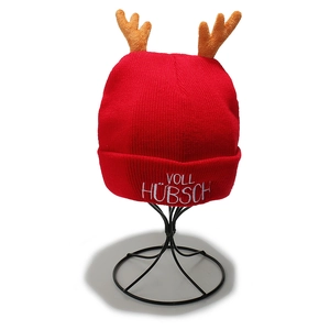Detail of red Christmas knit beanie with antlers and 'VOLL HÜBSCH' embroidery