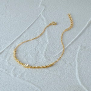 Macro detail of gold-plated silver bracelet with marquise and round zircon stones