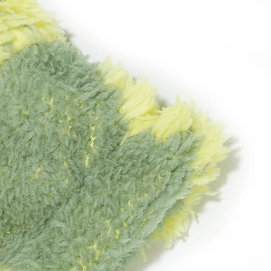 Close-up of soft green and yellow teddy velvet plush fabric texture for fisherman hat