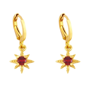 Macro detail of gold star earrings with ruby red zircon stone and huggie closure