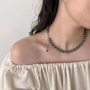 Elegant dark grey pearl necklace for women with silver chain shown on neck model