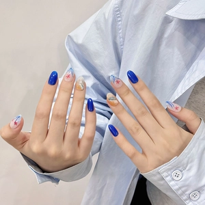Handmade ocean-themed press-on nails in blue and orange abstract art patterns