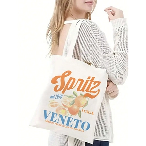 Close-up of a white canvas tote bag featuring a vintage Italian Spritz citrus graphic print