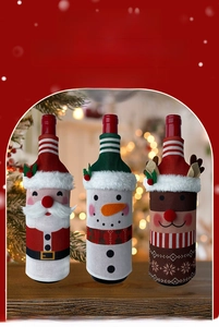 Detailed view of knitted Santa, Snowman, and Reindeer wine bottle covers for Christmas decor