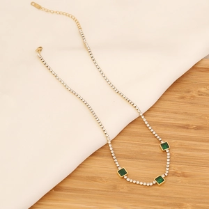Elegant gold-tone stainless steel necklace with three square emerald-green gemstones