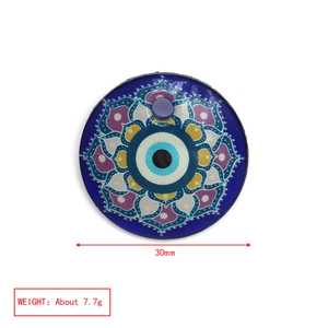 Detail view of a 30mm blue glass Evil Eye pendant with colorful mandala pattern