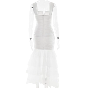 Detail of white bodycon dress featuring layered mesh fishtail hem and hidden back zipper