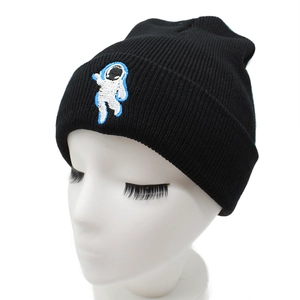 Black knit beanie with astronaut embroidery shown on a white mannequin head