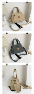 Detail of khaki and grey large capacity nylon crossbody bags with dual handles and logo