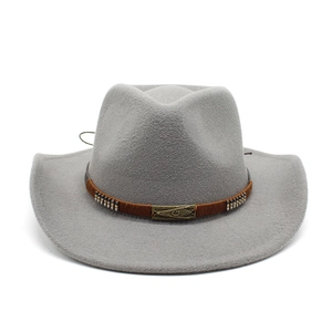 Detail of grey felt cowboy hat featuring brown braided band with metallic rivets