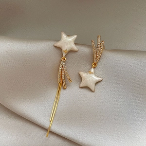 Asymmetric gold star fringe earrings with mother of pearl and shimmering zircons