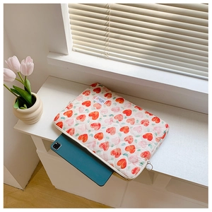 Quilted heart laptop sleeve showing tablet insertion in a cozy sunlit room setting