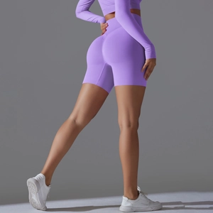 Detail view of purple high-waisted seamless yoga shorts showing contouring lifting effect